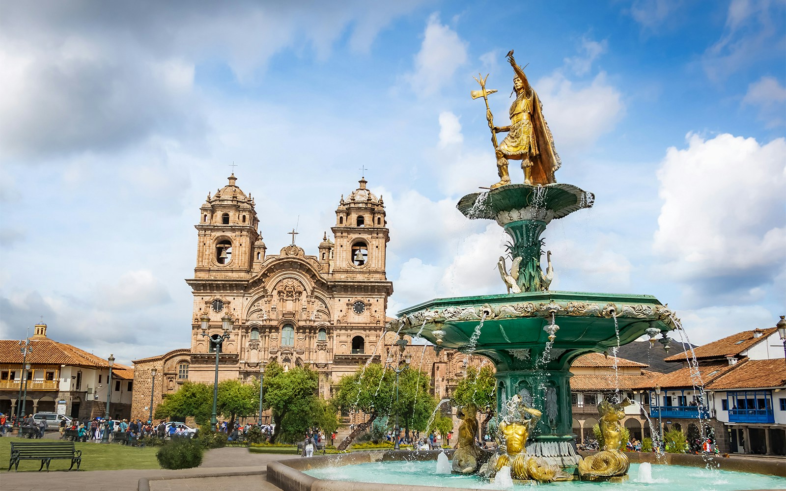 Tourists enjoying a sunny day on a Hop-on Hop-off tour bus in the historic city of Cusco, Peru