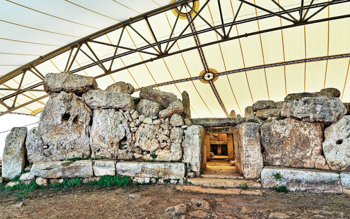 Hagar Qim megalithic temple complex under protective canopy in Malta.