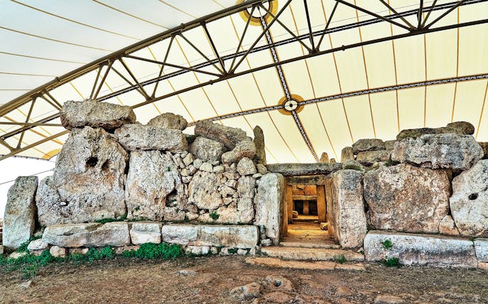 Hagar Qim megalithic temple complex under protective canopy in Malta.
