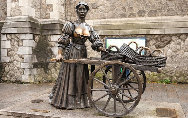 Molly Malone statue with cart and baskets in Dublin, Ireland.