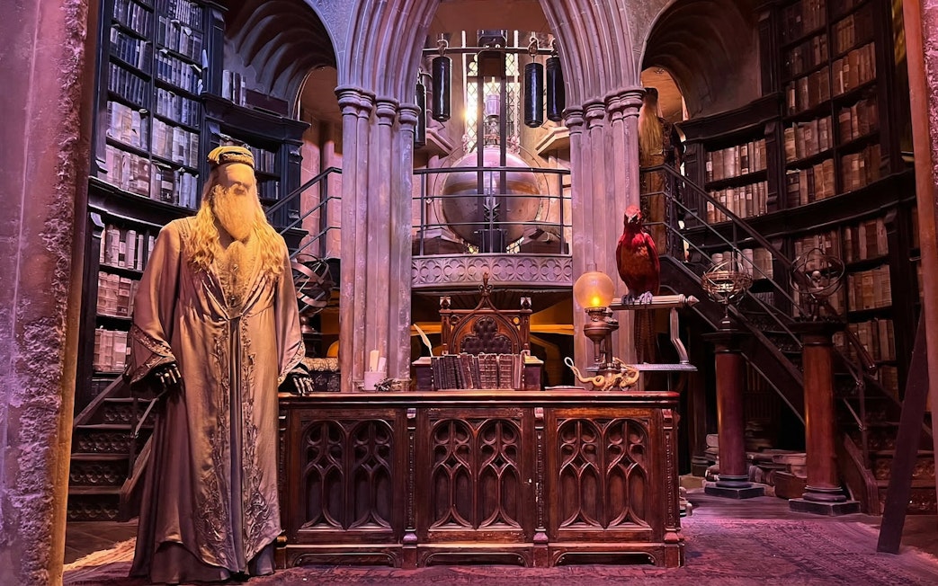 Dumbledore's office set at Harry Potter Studio Tour London with books and phoenix.