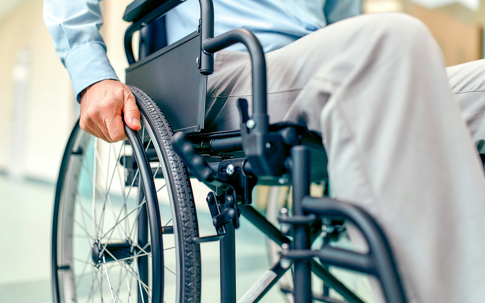 Person using a wheelchair indoors.