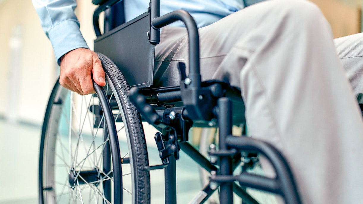 Person using a wheelchair indoors.