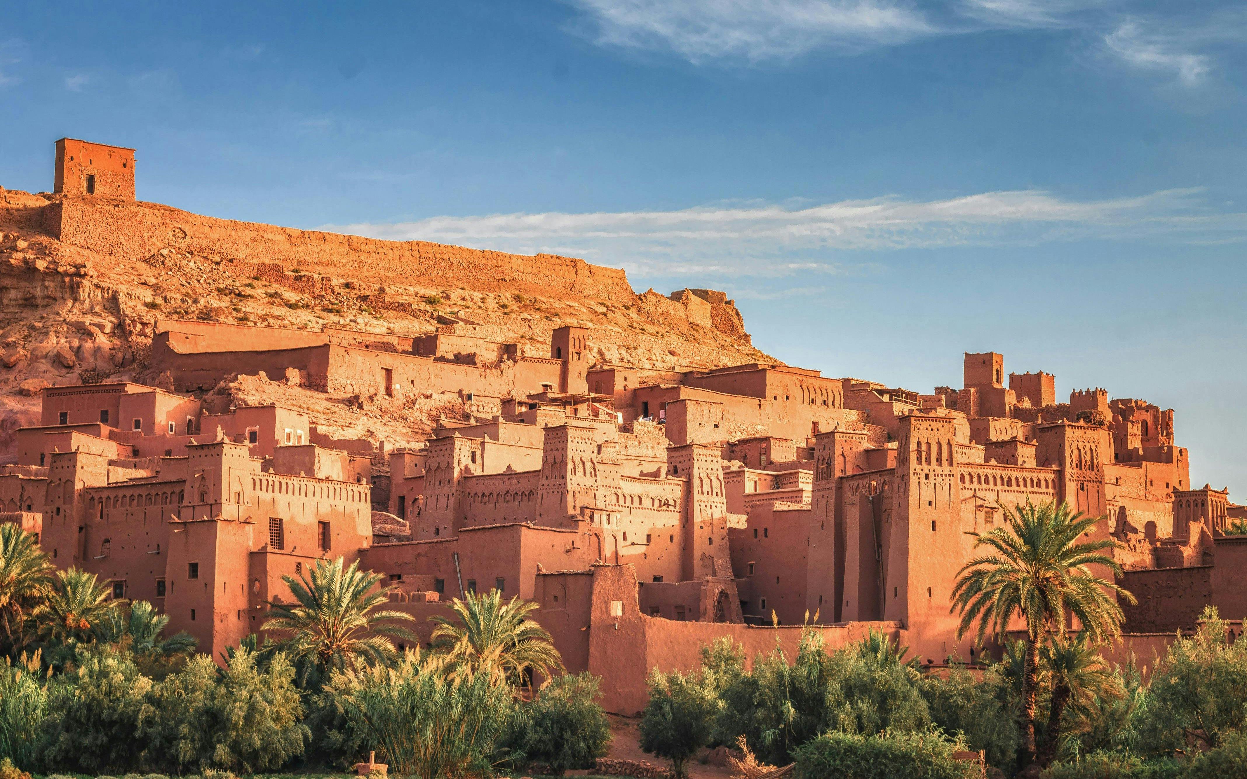 Ait Ben Haddou ancient clay buildings under a blue sky in Morocco.
