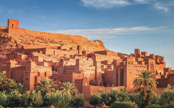 Ait Ben Haddou ancient clay buildings under a blue sky in Morocco.