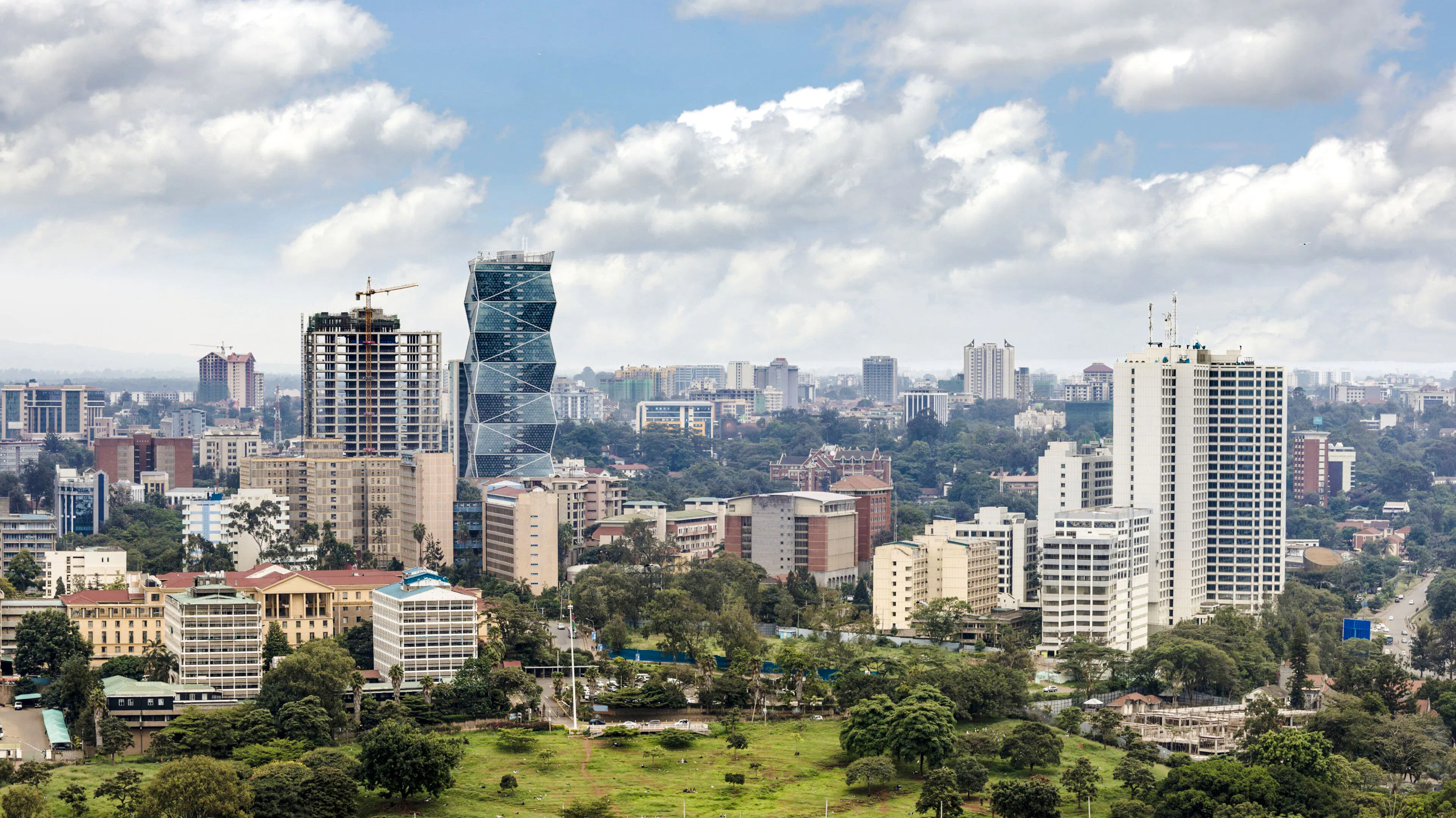 Nairobi cityscape with modern skyscrapers and lush greenery.