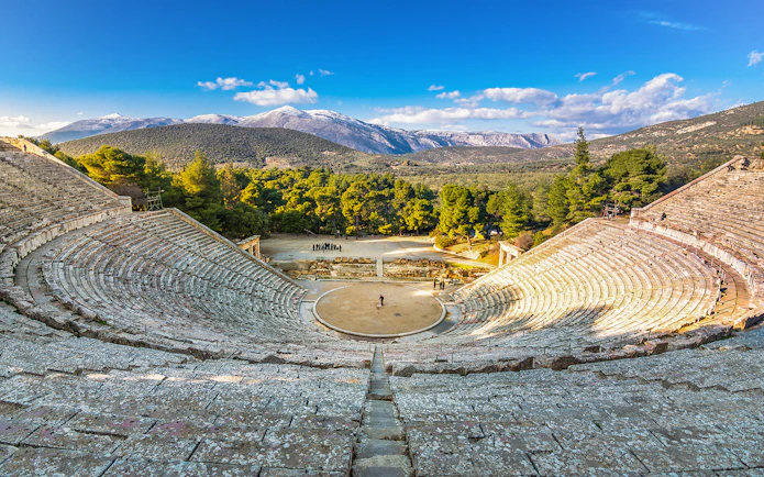 Epidaurus Ancient Theatre with scenic mountain backdrop in Greece.
