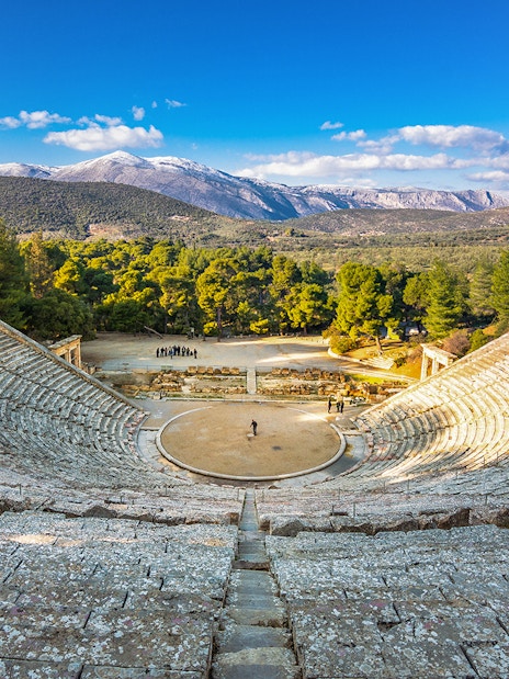 Epidaurus Ancient Theatre with scenic mountain backdrop in Greece.