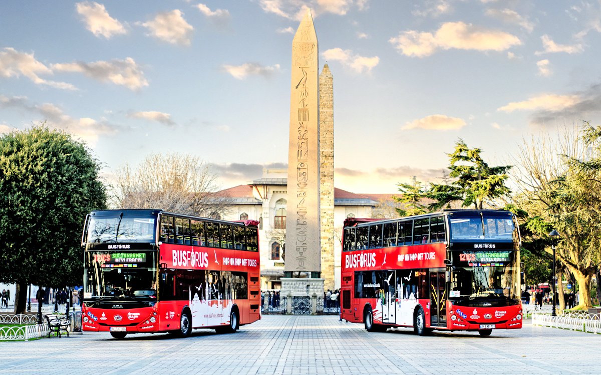 Hop on hop off buses near Obelisk of Theodosius in Istanbul.