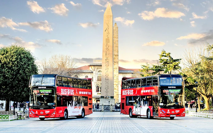 Hop on hop off buses near Obelisk of Theodosius in Istanbul.