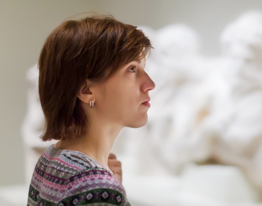 Woman looking at sculptures
