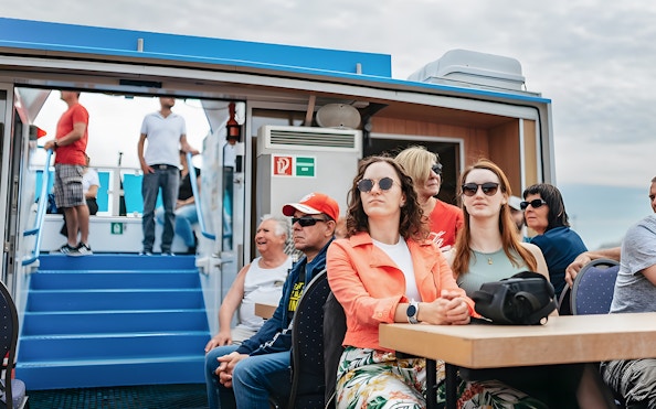 Passengers seated on a boat during the 2-Hour XXL Hamburg Harbor Cruise.