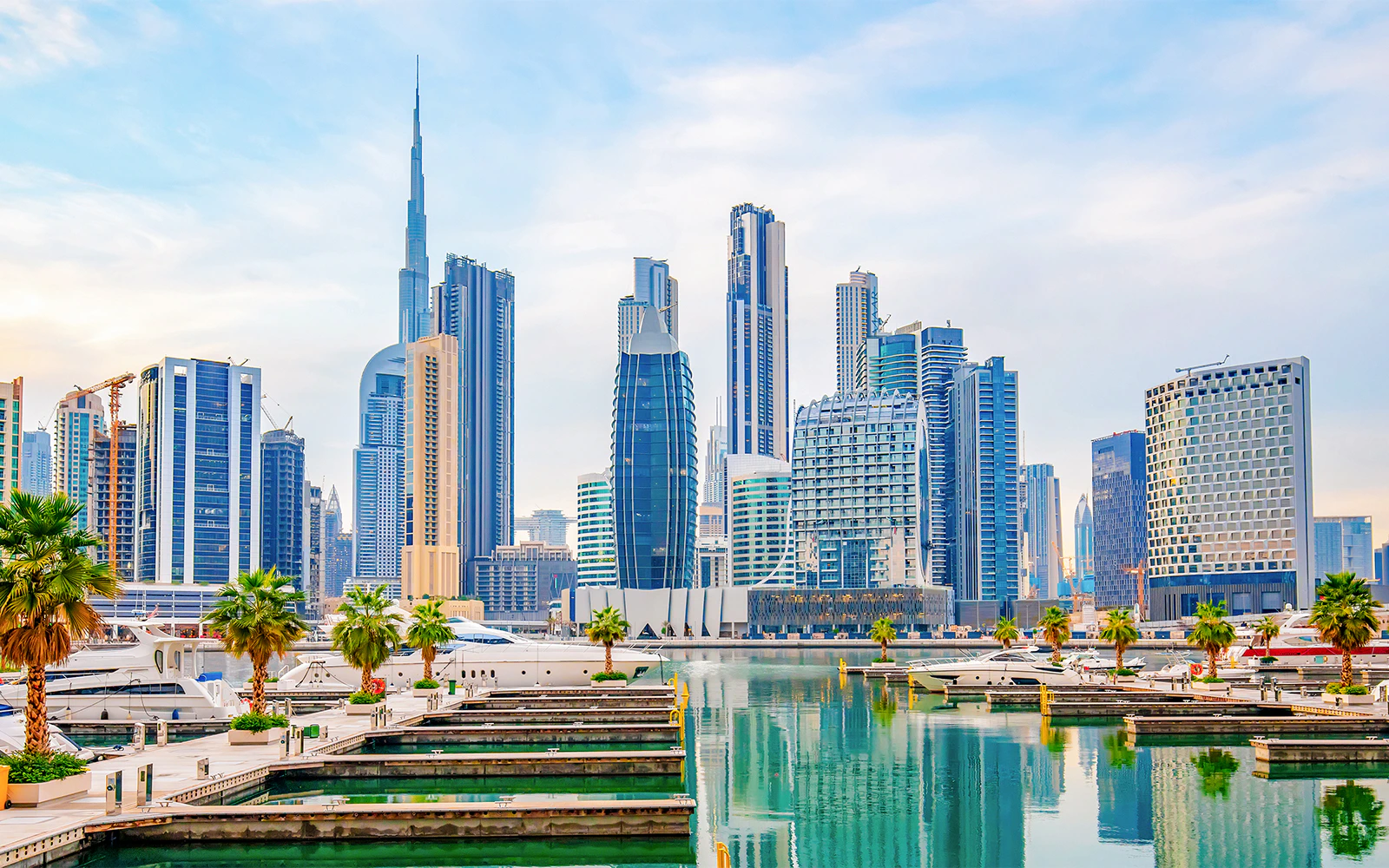 Dubai Business Bay skyline with marina and yachts, UAE.