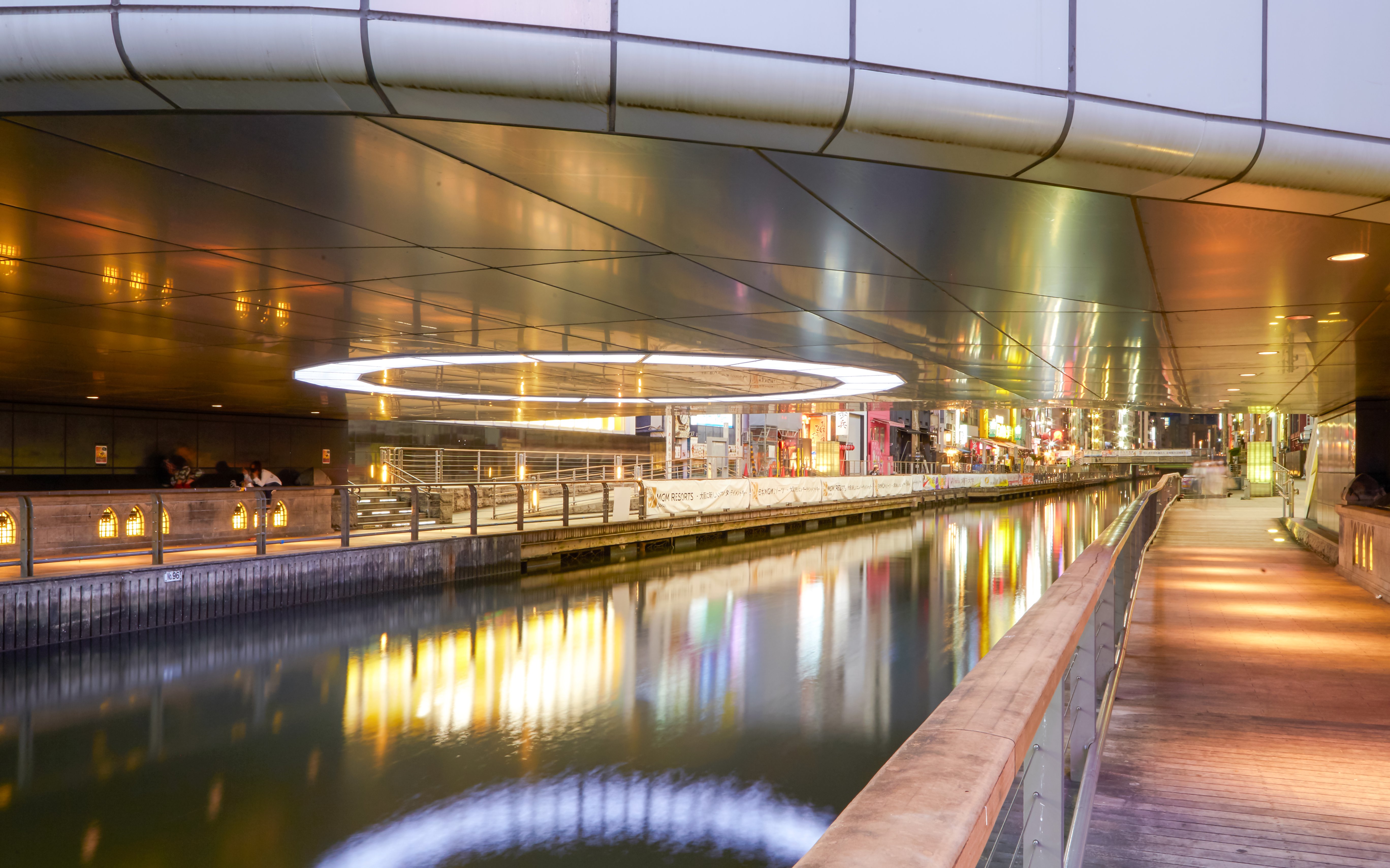 Night view of illuminated canal and walkway in Dotonbori, Minami, Osaka.