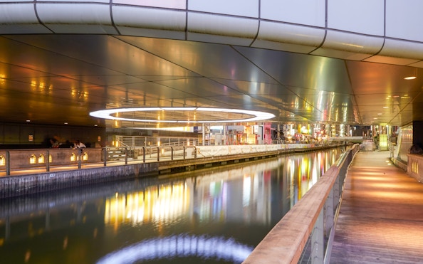 Night view of illuminated canal and walkway in Dotonbori, Minami, Osaka.
