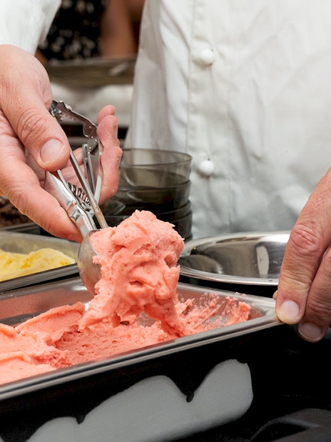 Scooping gelato during a cooking class in Rome.