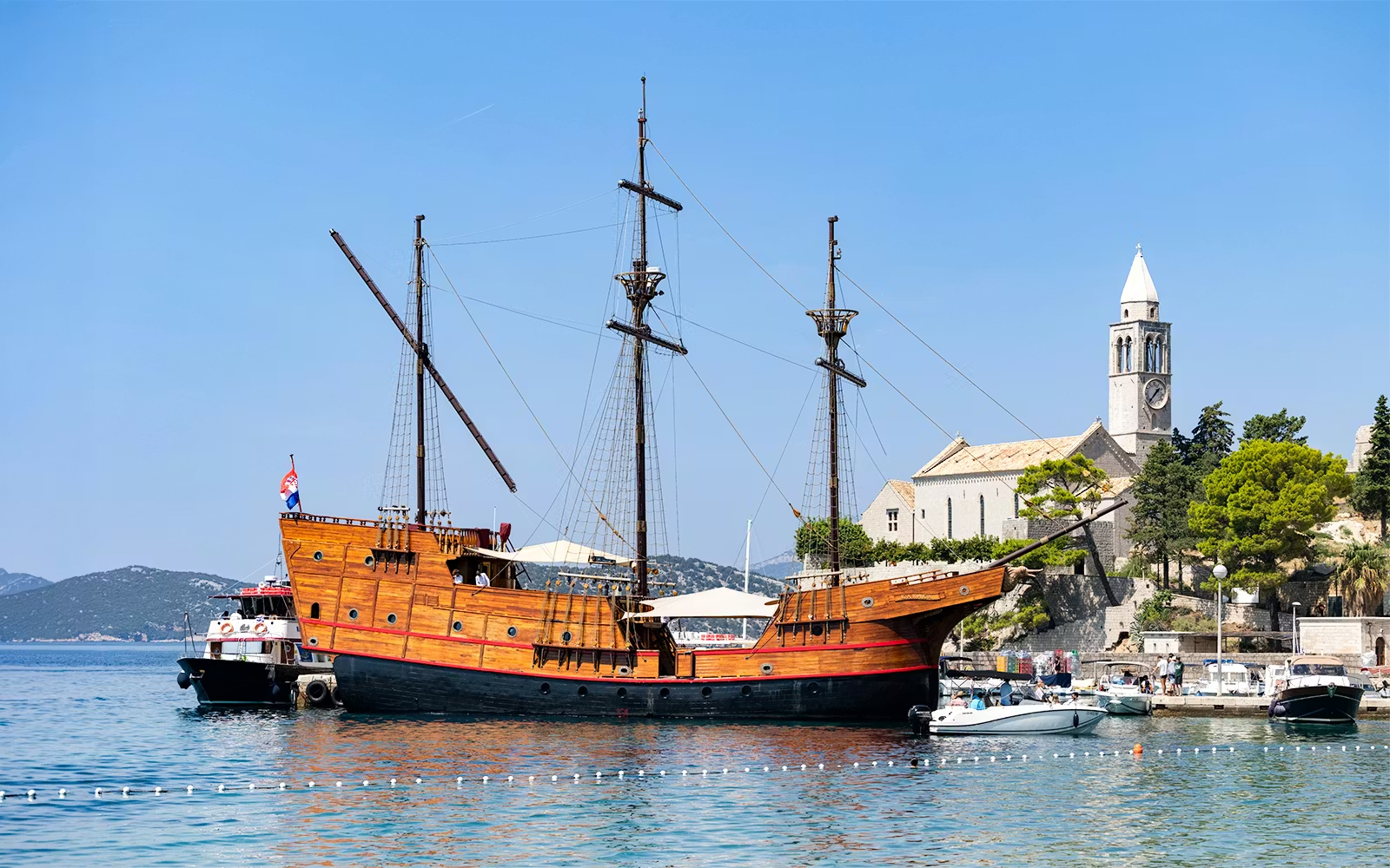 Karaka ship docked near a historic church on the Elaphite Islands cruise.