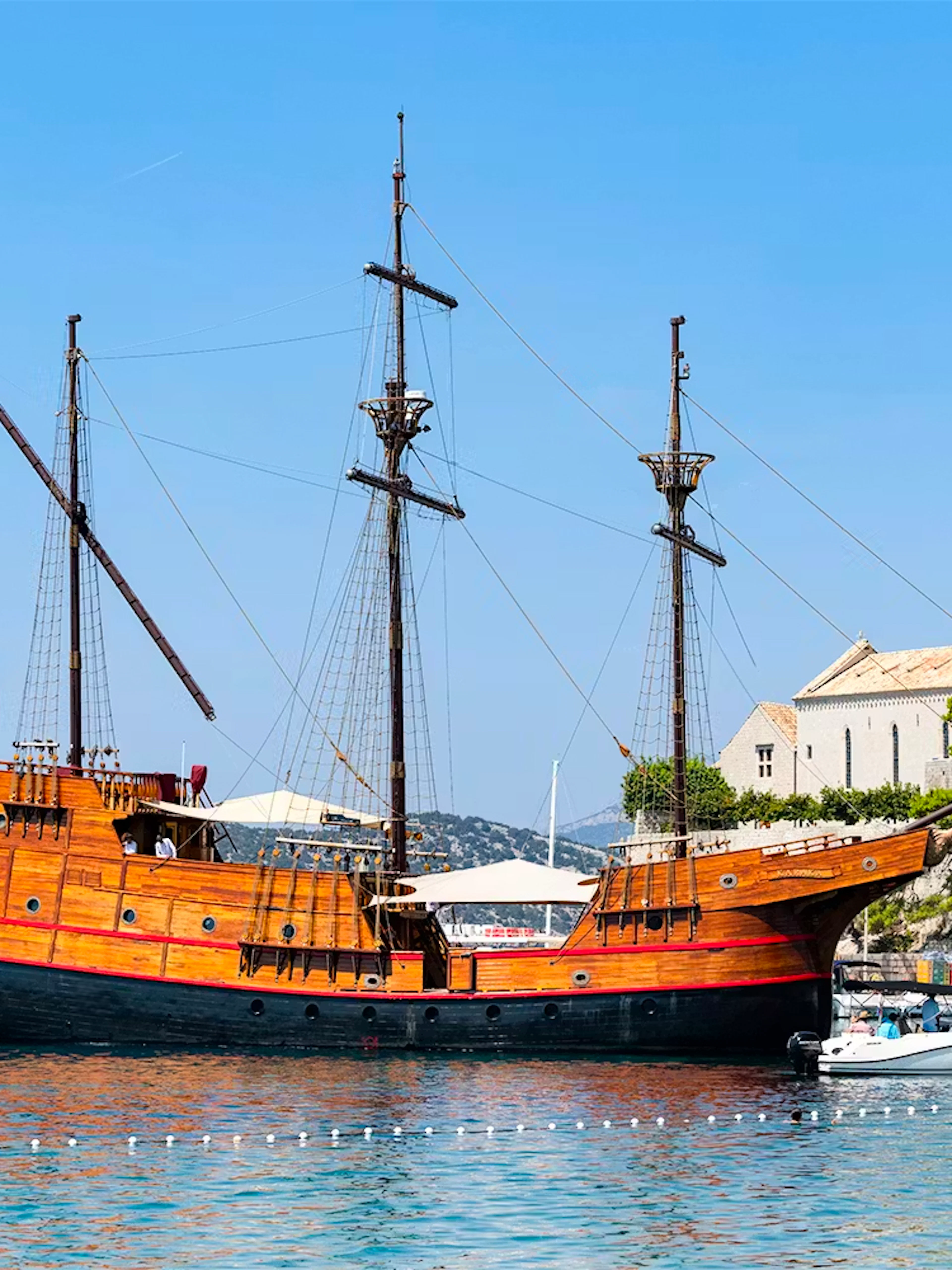 Karaka ship docked near a historic church on the Elaphite Islands cruise.