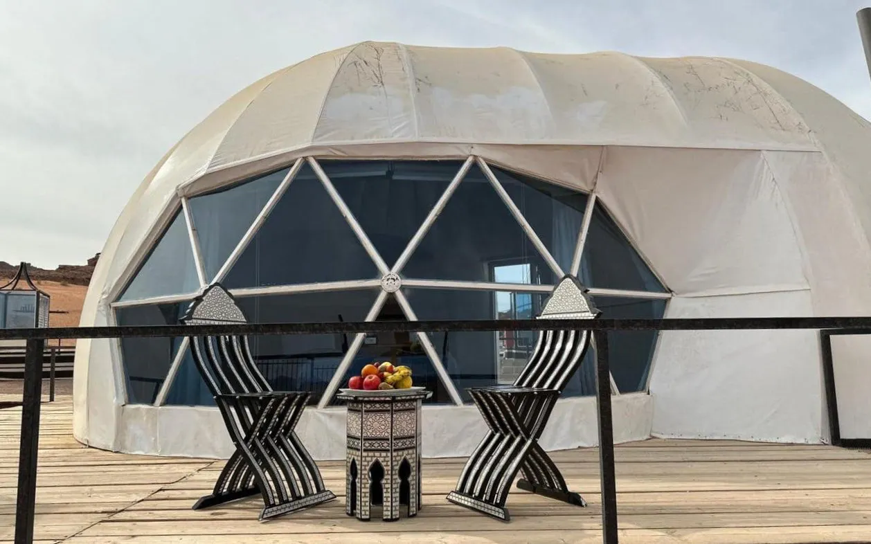 Geodesic dome tent with chairs and table at Wadi Rum campsite, Jordan.