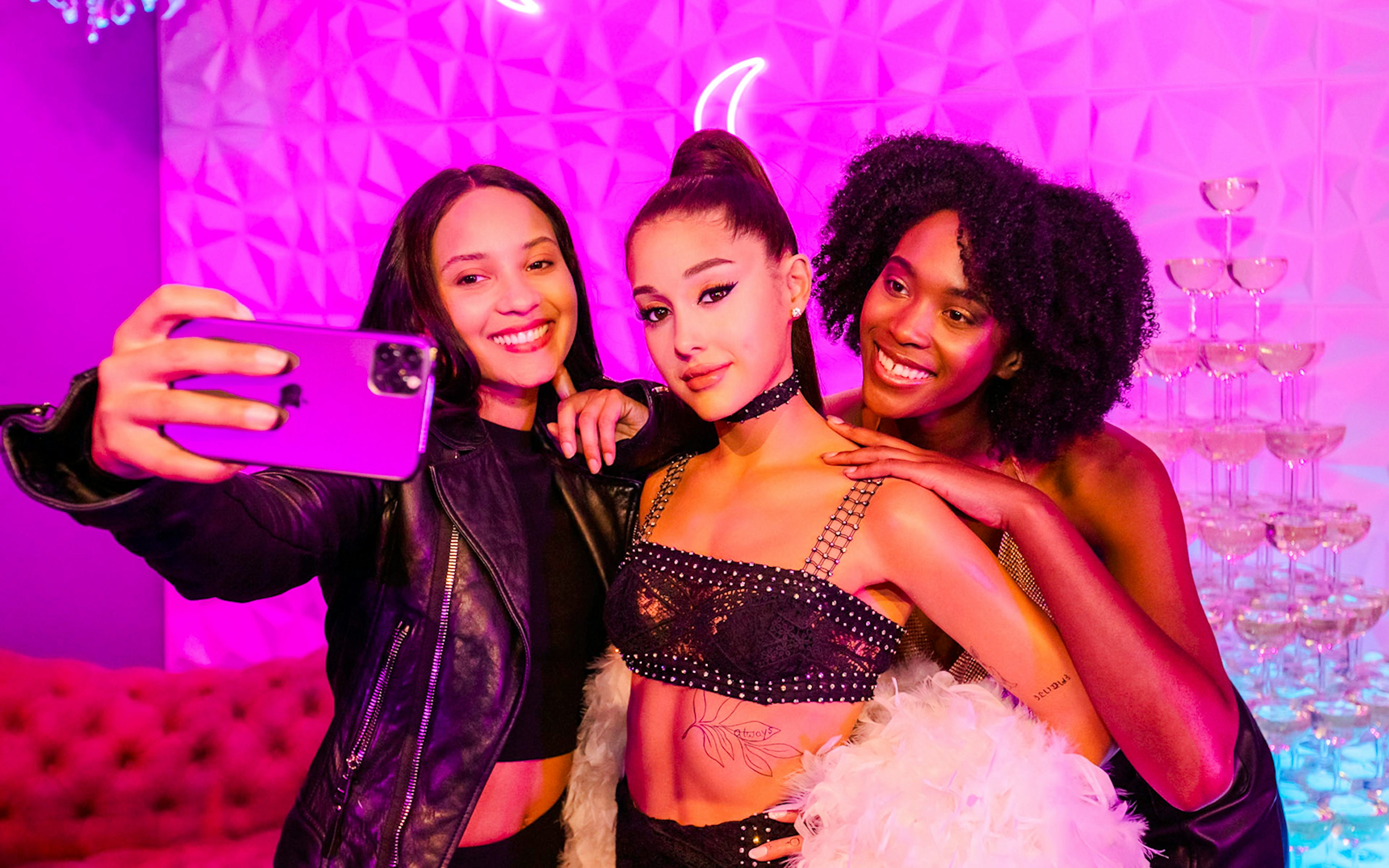 Visitors taking a selfie with Ariana Grande statue at Madame Tussauds Hollywood.