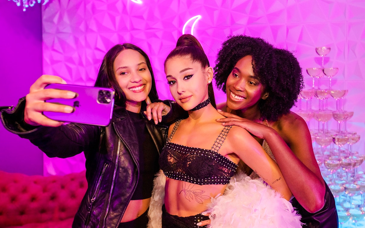 Visitors taking a selfie with Ariana Grande statue at Madame Tussauds Hollywood.