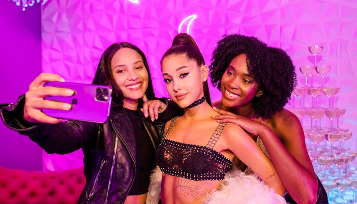 Visitors taking a selfie with Ariana Grande statue at Madame Tussauds Hollywood.