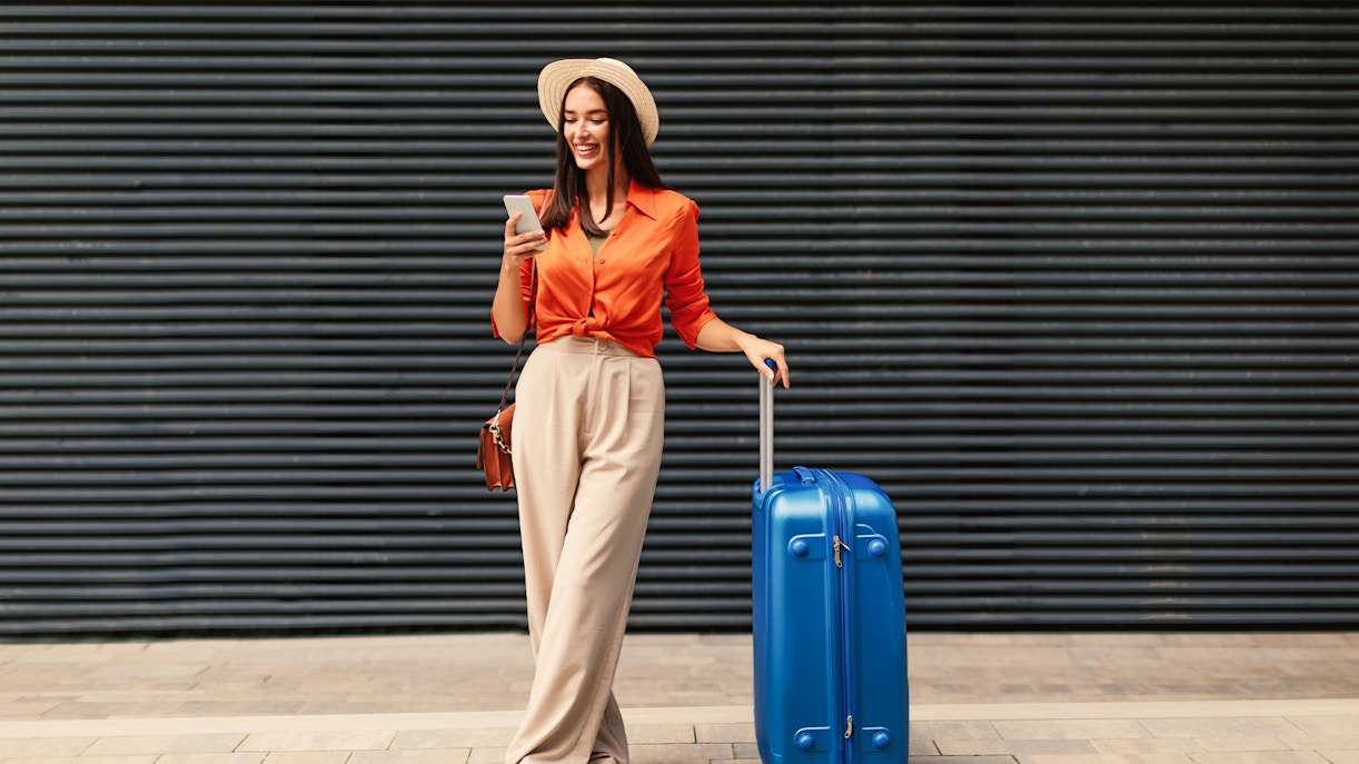 Traveler Woman Using Phone to Book Ticket