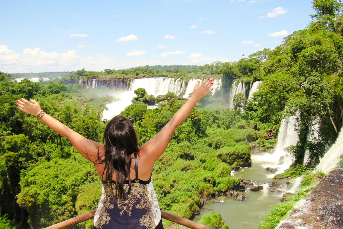 Visitor enjoying the view of Iguazu Falls from a lookout point, Foz do Iguaçu, Brazil.