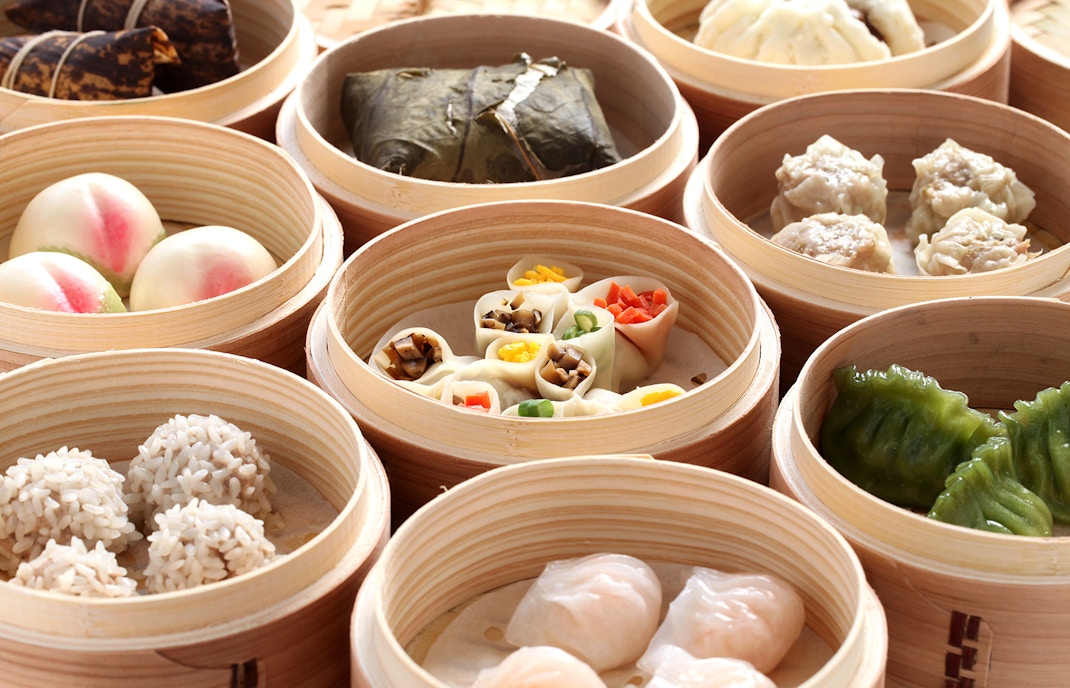 Vegan Asian dishes with vegetables and tofu on a table.