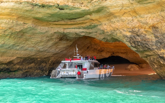 Boat entering Benagil Caves in Algarve, Portugal.