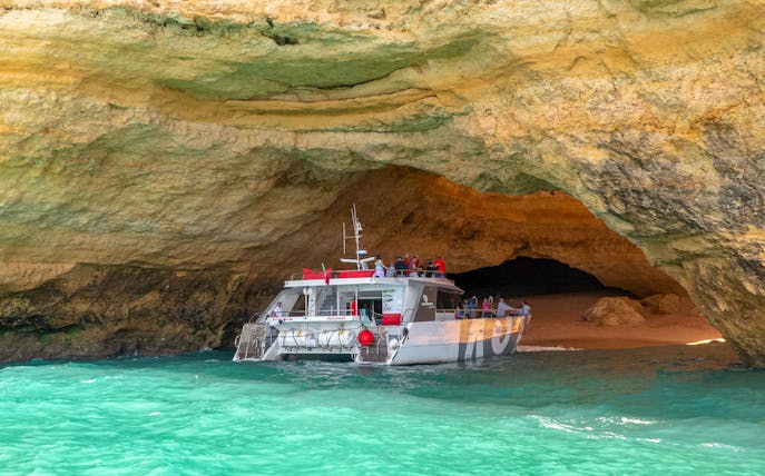 Boat entering Benagil Caves in Algarve, Portugal.