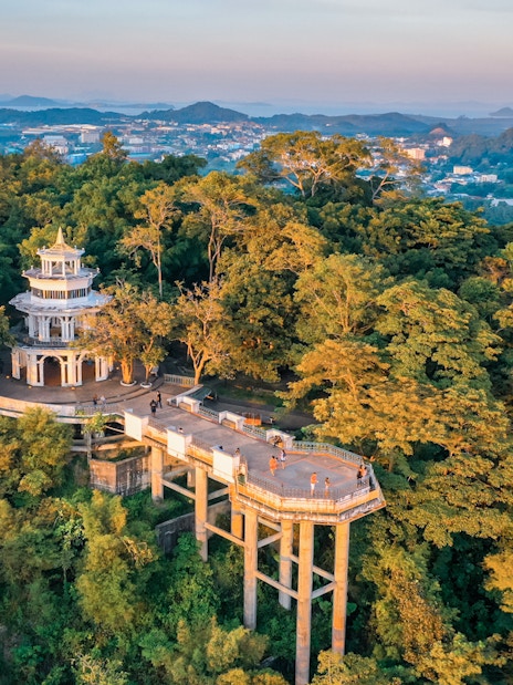Aerial view of Khao Rang viewpoint in Phuket surrounded by lush greenery.