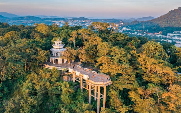 Aerial view of Khao Rang viewpoint in Phuket surrounded by lush greenery.