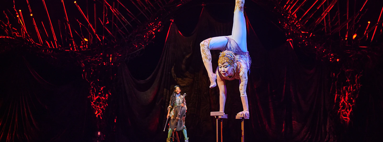 Acrobat performing handstand at Cirque du Soleil: Alegría in Seville.