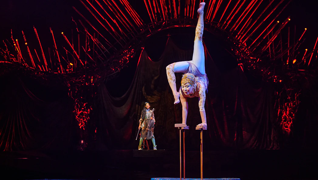 Acrobat performing handstand at Cirque du Soleil: Alegría in Seville.