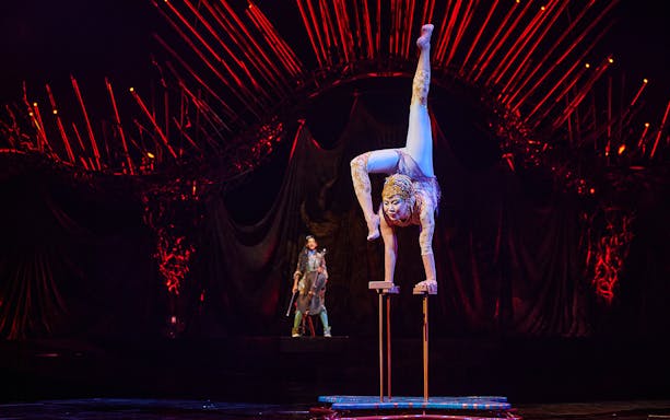 Acrobat performing handstand at Cirque du Soleil: Alegría in Seville.