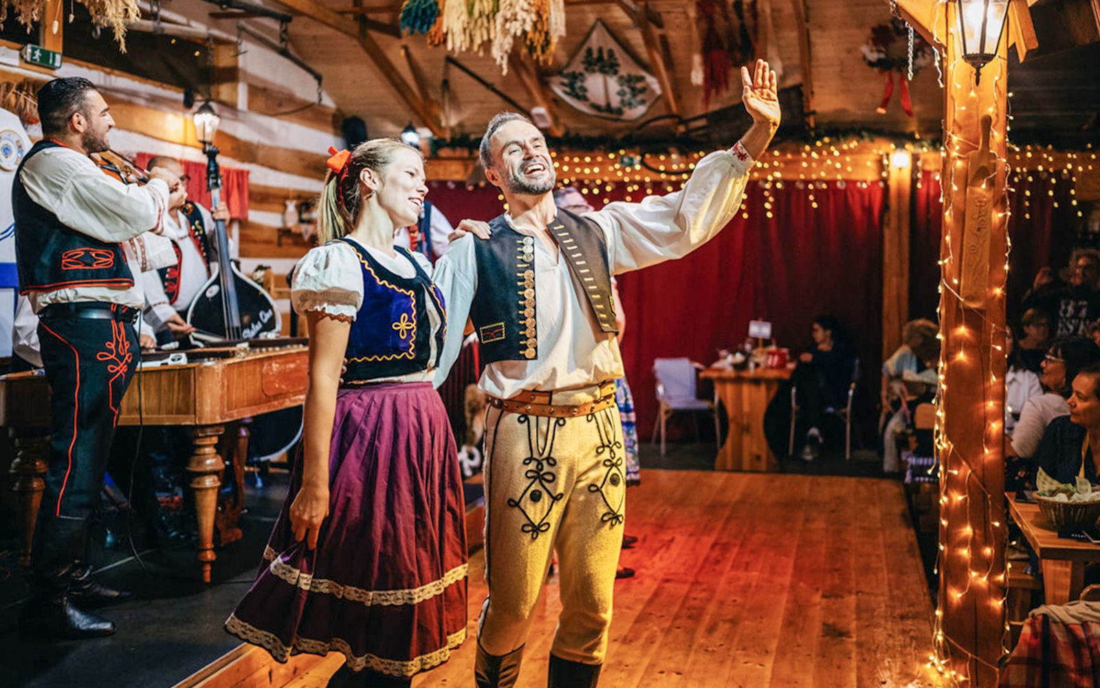 Performers in traditional attire during Folklore Dinner Show in Prague.