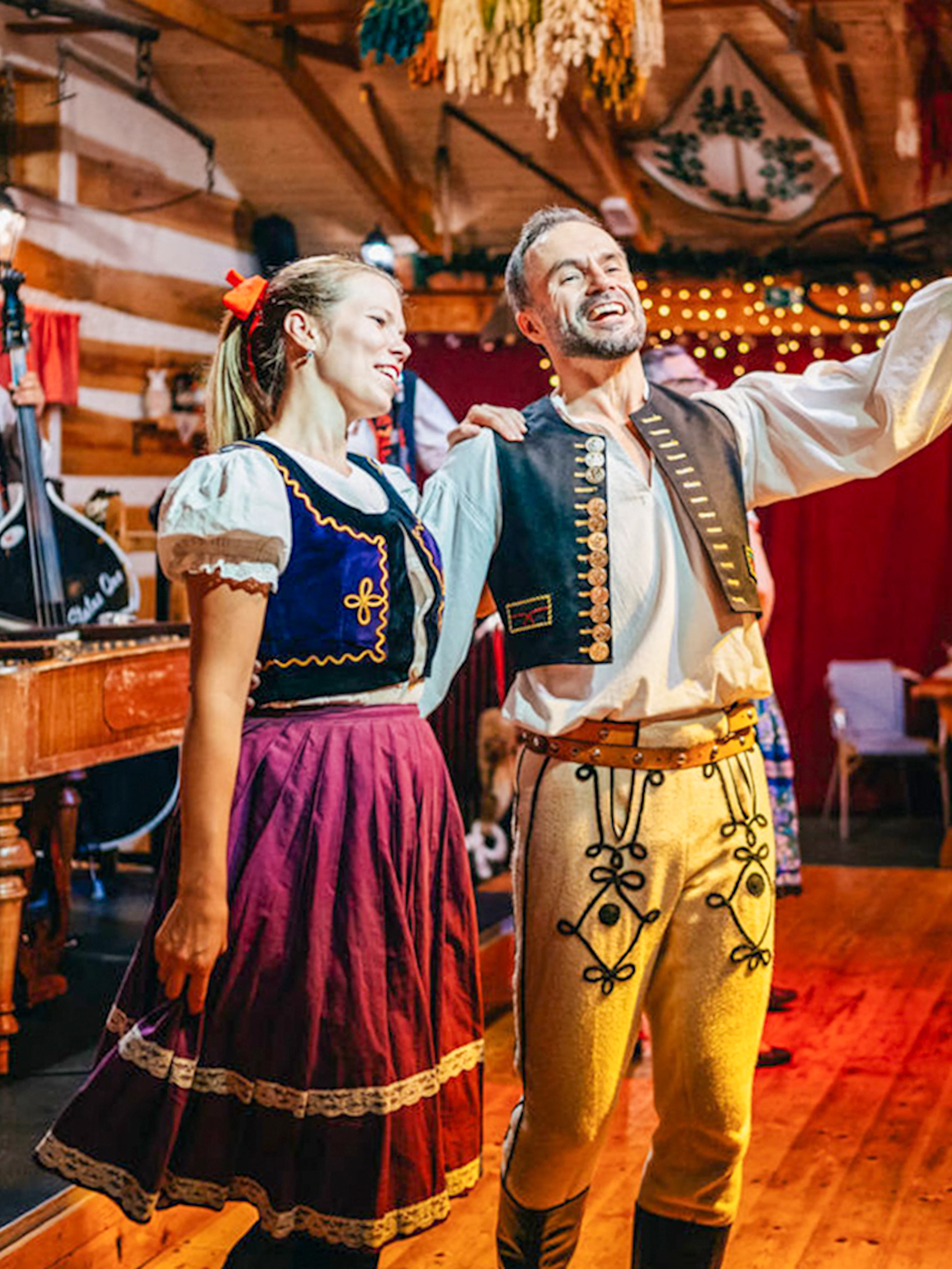 Performers in traditional attire during Folklore Dinner Show in Prague.