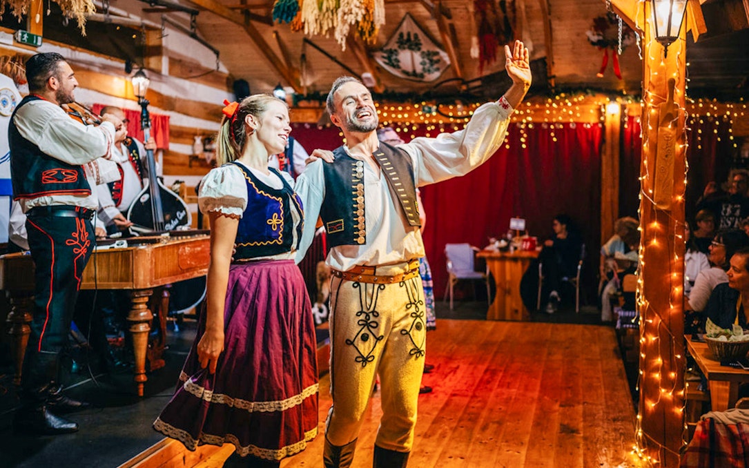Performers in traditional attire during Folklore Dinner Show in Prague.