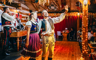 Performers in traditional attire during Folklore Dinner Show in Prague.