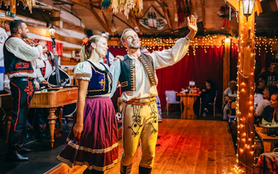 Performers in traditional attire during Folklore Dinner Show in Prague.