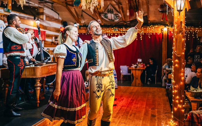 Performers in traditional attire during Folklore Dinner Show in Prague.