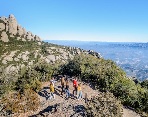 tourists with guide during hike to montserrat monastery