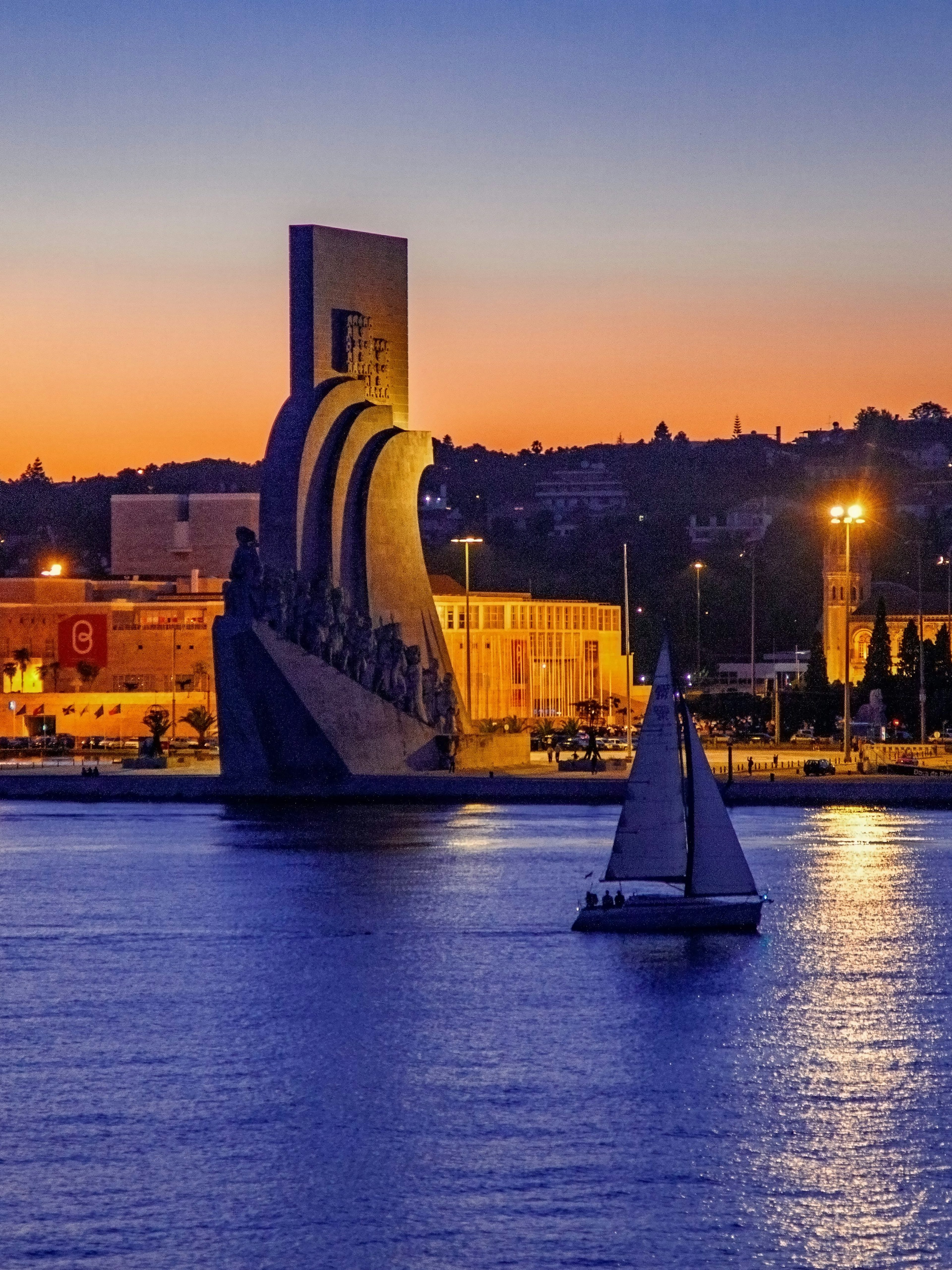 Lisbon nighttime cruise passing the Monument of Discoveries.
