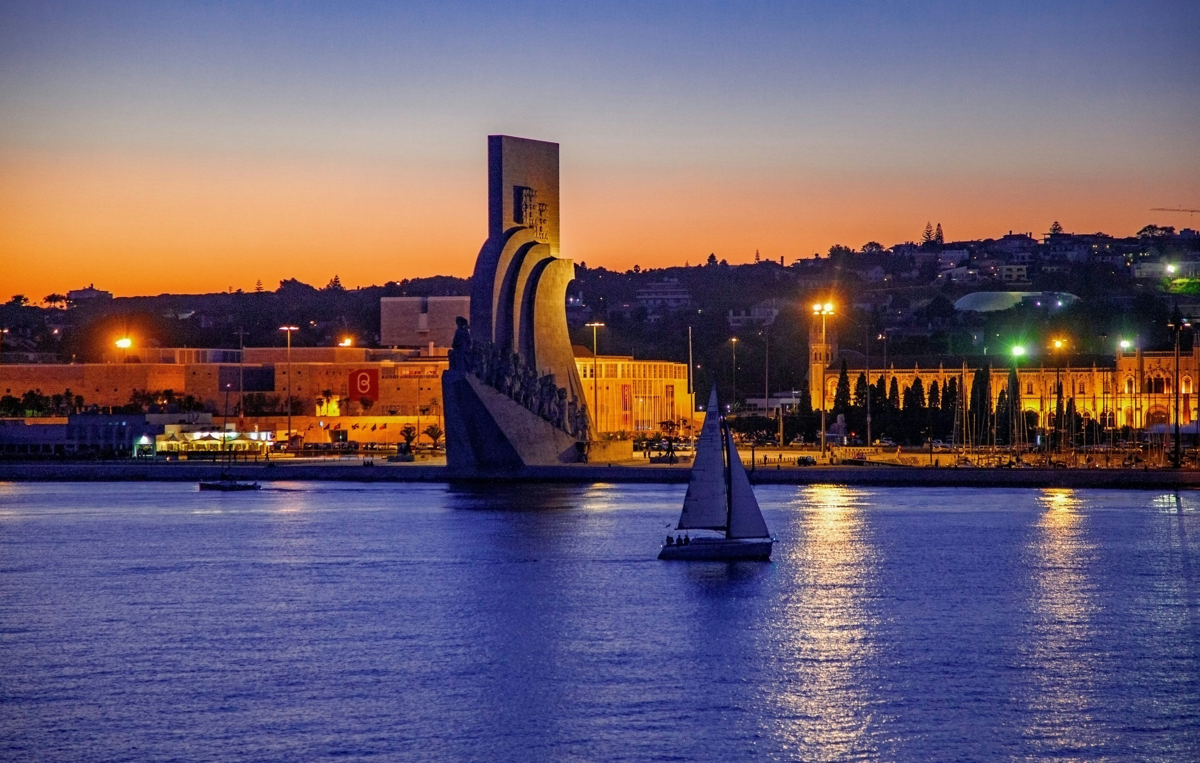 Lisbon nighttime cruise passing the Monument of Discoveries.