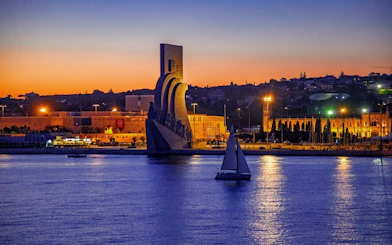 Lisbon nighttime cruise passing the Monument of Discoveries.