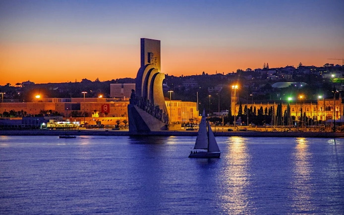 Lisbon nighttime cruise passing the Monument of Discoveries.
