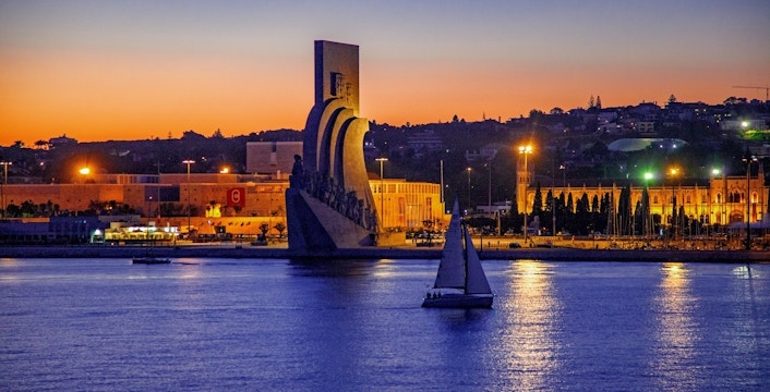 Lisbon nighttime cruise passing the Monument of Discoveries.