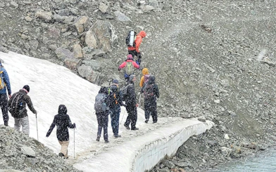 Group trekking on snowy path at Vinciguerra Glacier, Argentina.