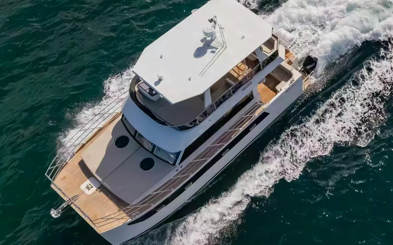 Luxury boat cruising on blue waters during Hobart Half-Day Fishing, Diving & Gourmet Cruise.